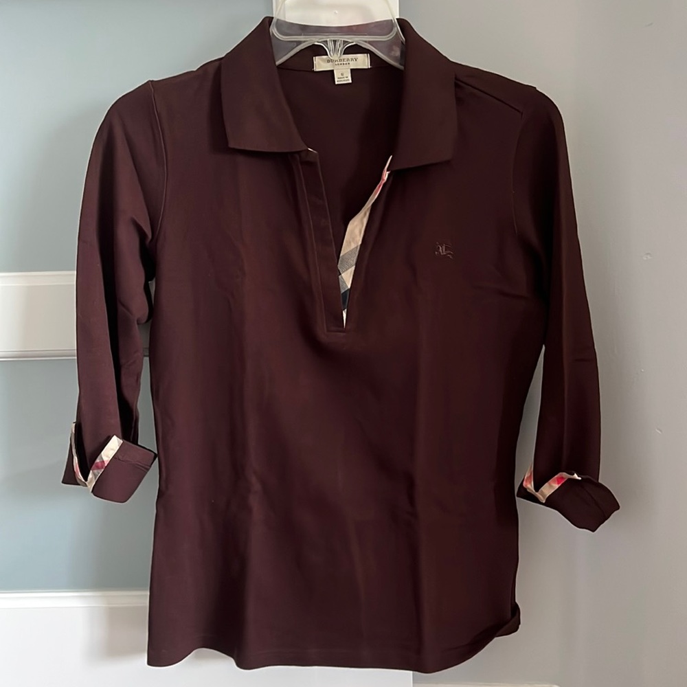 Burberry polo with peek-a-boo vintage print sleeve detail.